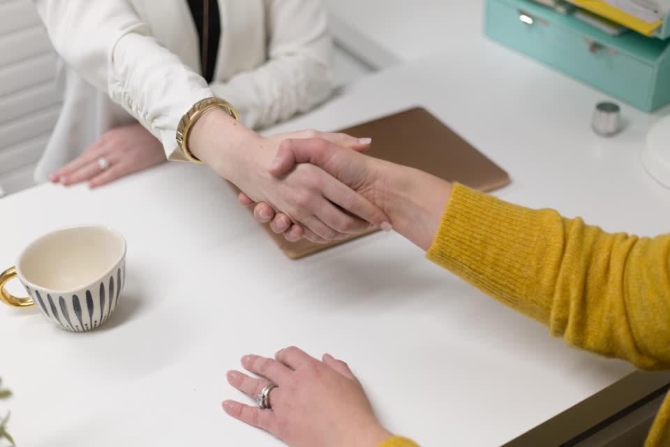 Two people shaking hands after a business meeting